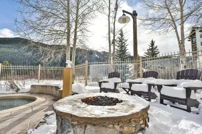 a patio with a fire pit in the snow at Red Hawk Townhome - Walk to Lifts, Pool/Hot Tub Access in Keystone