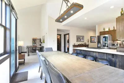 a kitchen with a long wooden table and chairs at Red Hawk Townhome - Walk to Lifts, Pool/Hot Tub Access in Keystone