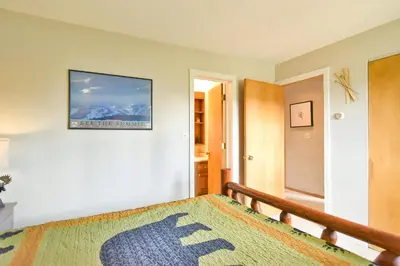 a bedroom with a bed with a picture on the wall at Timber Ridge Retreat - Pool, Hot Tub, Sauna + More in Silverthorne