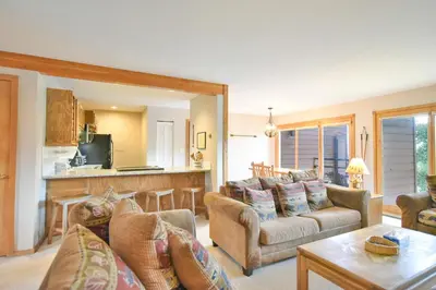 a living room with a couch and a table at Timber Ridge Retreat - Pool, Hot Tub, Sauna + More in Silverthorne