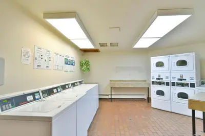 a laundry room with white counters and washing machines at Timber Ridge Retreat - Pool, Hot Tub, Sauna + More in Silverthorne