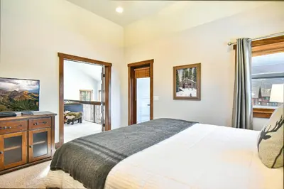 a bedroom with a bed and a television in it at Shekel Haus – Luxury Mountain Retreat w/ Views Hot Tub in Breckenridge