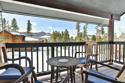 a table and chairs on a balcony with a view at Shekel Haus – Luxury Mountain Retreat w/ Views Hot Tub in Breckenridge