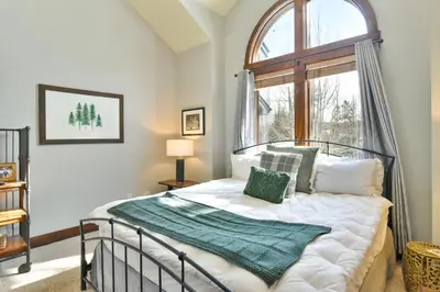 a bedroom with a bed and a window at Shekel Haus – Luxury Mountain Retreat w/ Views Hot Tub in Breckenridge