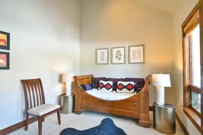 a bedroom with a bed with pillows and a chair at Shekel Haus – Luxury Mountain Retreat w/ Views Hot Tub in Breckenridge
