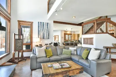 a living room with a couch and a table at Shekel Haus – Luxury Mountain Retreat w/ Views Hot Tub in Breckenridge