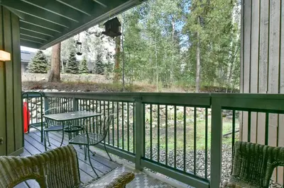 a screened porch with a table and chairs on it at Wild Irishman RR Chalet: Fantastic Keystone Getaway in Keystone