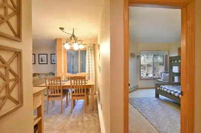 a dining room and living room with a table and chairs at Wild Irishman RR Chalet: Fantastic Keystone Getaway in Keystone