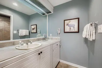 a bathroom with a sink and a mirror at 2747 Slopeside studio in Keystone