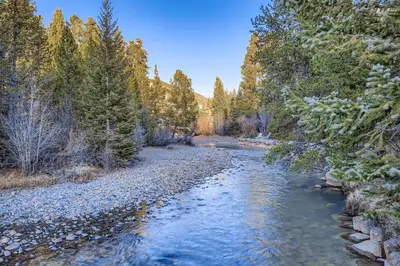 a river in the middle of a forest at 2747 Slopeside studio in Keystone