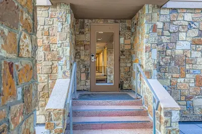 a stone building with stairs leading to a door at 2747 Slopeside studio in Keystone