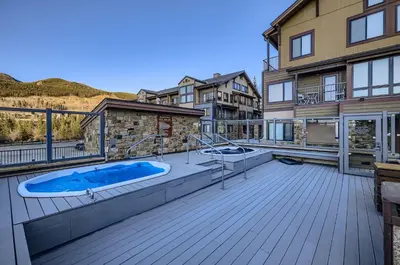 a hot tub on the deck of a house at 2747 Slopeside studio in Keystone