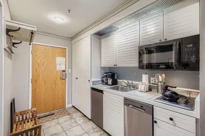 a kitchen with a sink and a microwave at 2747 Slopeside studio in Keystone
