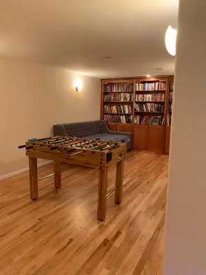 a living room with a table and a couch at Private Basement Suite Bedrooms Bath Kitchen office Theater in Broomfield