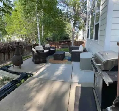 a patio with couches and a grill next to a house at Private Basement Suite Bedrooms Bath Kitchen office Theater in Broomfield