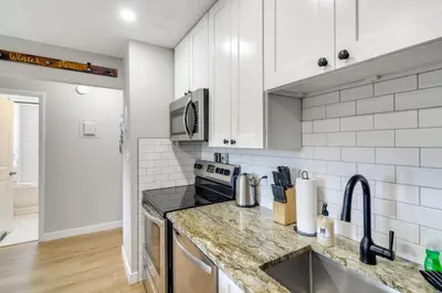 a kitchen with white cabinets and a counter top at 3BR Riverfront Retreat! Mtn Views, Community Perks in Winter Park