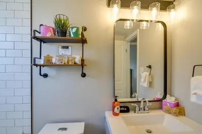 a bathroom with a sink and a mirror at 3BR Riverfront Retreat! Mtn Views, Community Perks in Winter Park