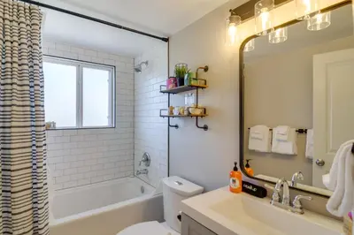 a bathroom with a tub and a toilet and a sink at 3BR Riverfront Retreat! Mtn Views, Community Perks in Winter Park