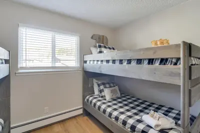 a bedroom with a bunk bed and a window at 3BR Riverfront Retreat! Mtn Views, Community Perks in Winter Park