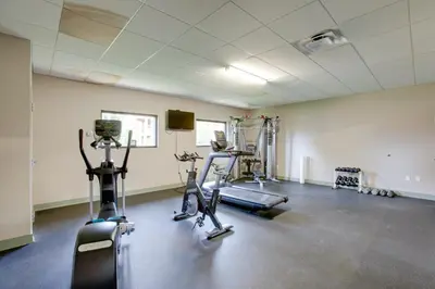 a gym with two treadmills and two exercise bikes at 3BR Riverfront Retreat! Mtn Views, Community Perks in Winter Park