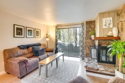 a living room with a couch and a fireplace at Hot Tub Access Condo 2 Mi to Winter Park Resort! in Winter Park