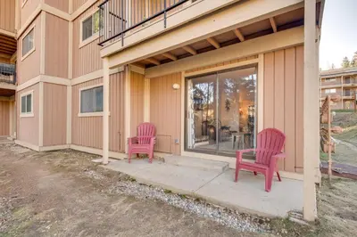 two pink chairs sitting on the porch of a house at Hot Tub Access Condo 2 Mi to Winter Park Resort! in Winter Park