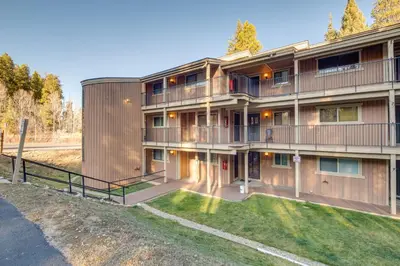 an apartment building with a lawn in front of it at Hot Tub Access Condo 2 Mi to Winter Park Resort! in Winter Park
