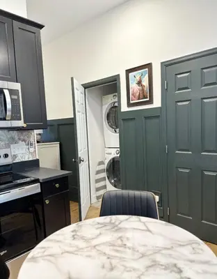 a kitchen with a table and a washer and dryer at RiNo Retreat Flat walkable and great location in Denver