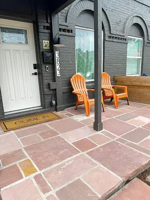 two wooden benches sitting on a patio near a door at RiNo Retreat Flat walkable and great location in Denver