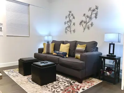 a living room with a couch and two lamps at Steps to Lake Fireplace Indoor Outdoor Oasis in Grand Lake
