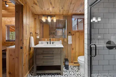 a bathroom with a sink and a toilet at Cabin 2- Two BR Cabin w Hot Tub in Estes Park