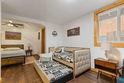 a bedroom with two beds and a window at Cabin 3- Cozy updated cabin 5 min to RMNP in Estes Park
