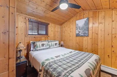 a bedroom with a bed and a ceiling fan at Cabin 4- One Bedroom cabin- RMNP in Estes Park