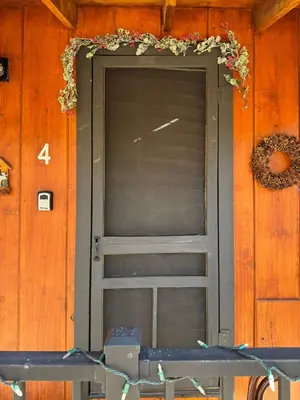 a door on a building with areath on it at Cabin 4- One Bedroom cabin- RMNP in Estes Park
