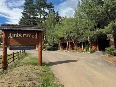 a sign for the entrance to an antlerwood sign at Cabin 4- One Bedroom cabin- RMNP in Estes Park