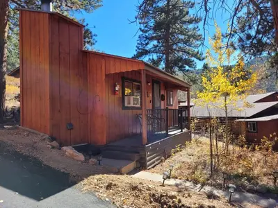 a small wooden house with a porch and stairs at Cabin 4- One Bedroom cabin- RMNP in Estes Park