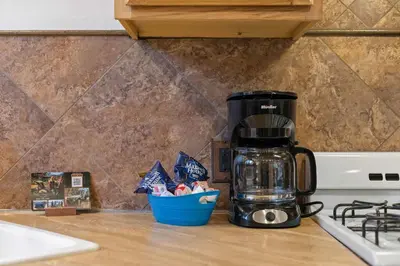 a coffeemaker sitting on a counter next to a coffee pot at Cabin 5- Private Cabin w King bed kitchen porch in Estes Park