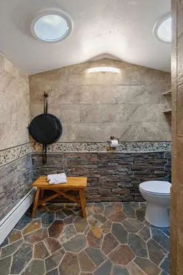 a bathroom with a toilet and a wooden table at Cabin 5- Private Cabin w King bed kitchen porch in Estes Park