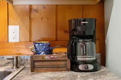 a coffee maker sitting on a counter next to a sink at Cabin 6- Private Hot Tub 5 Min to RMNP in Estes Park