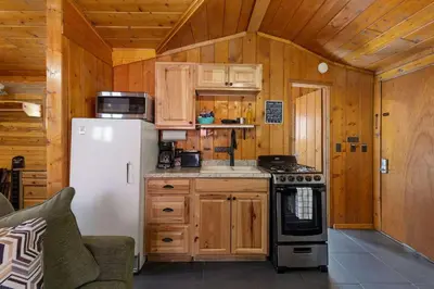a kitchen with a refrigerator and a stove at Cabin 7- Studio Cabin Heated Floors 5 Min to RMNP in Estes Park