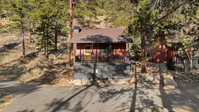 a small house on the side of a road at Cabin 8-Cozy King Loft Cabin 5 Min to RMNP in Estes Park