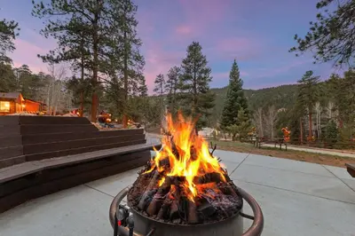 a large fire in a pot on a sidewalk at Cabin 8-Cozy King Loft Cabin 5 Min to RMNP in Estes Park