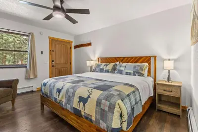 a bedroom with a bed and a ceiling fan at Cabin 14 - King Bed hotel-style unit in Estes Park
