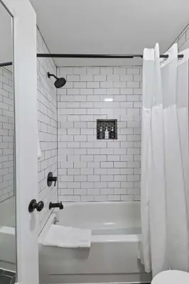 a white bathroom with a tub and a shower at Cabin16 - King Bed Kitchenette & Bath in Estes Park