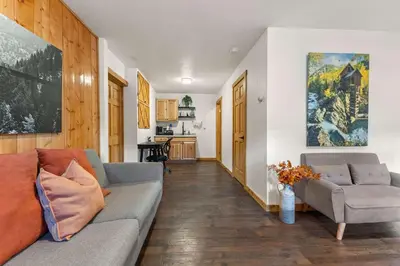 a living room with a couch and a table at Cabin 18 - King Bed Mountain views Hotel Style in Estes Park