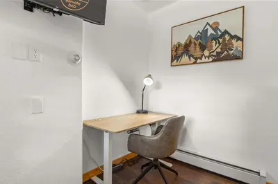 a desk with a chair and a lamp on a wall at Cabin 18 - King Bed Mountain views Hotel Style in Estes Park