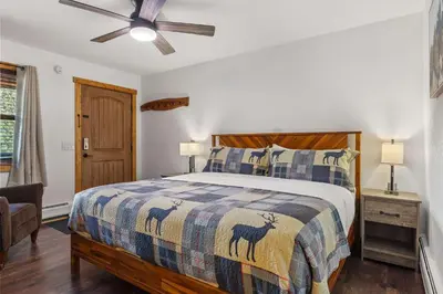 a bedroom with a bed and a ceiling fan at Cabin 19- King Studio Gorgeous views Hotel Style in Estes Park