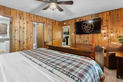 a bedroom with a bed and a ceiling fan at Cabin 20- King Cabin w Roku TV Full Kitchen in Estes Park