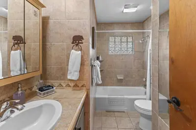 a bathroom with a sink and a toilet and a tub at Cabin 20- King Cabin w Roku TV Full Kitchen in Estes Park