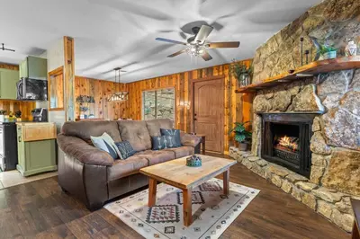 a living room with a couch and a fireplace at Cabin 20- King Cabin w Roku TV Full Kitchen in Estes Park